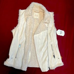 Never been worn new with tags has a small red spot as shown in the picture